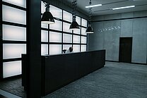 Lonely man sits at the huge reception desk