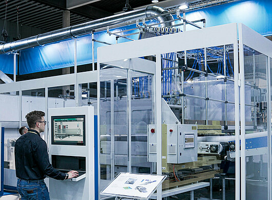 User at HMI in front of a machine cabin